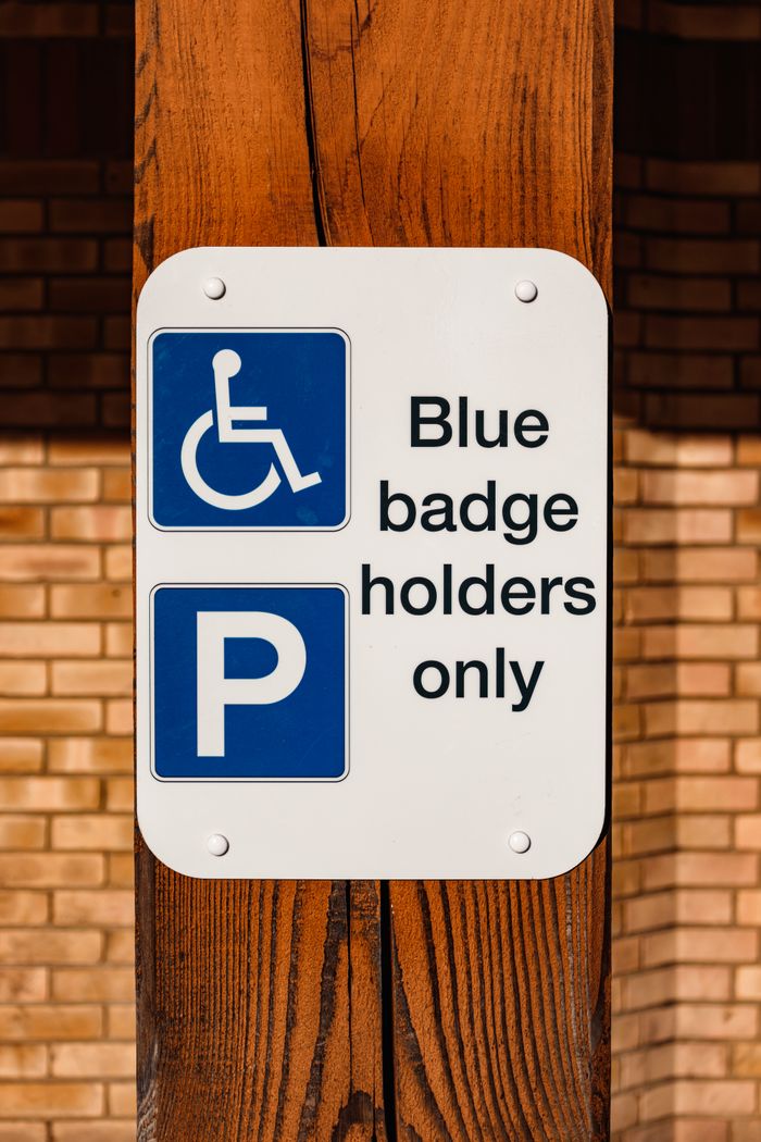 The Art of Drawing Readers In: Your attractive post title goes here A sign indicating parking for blue badge holders only, outdoors.